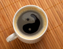 Little white espresso coffee cup on a bamboo mat (upprer view)